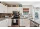 Beautiful kitchen with stainless steel appliances, granite counters, white cabinets, and a bright window at 8056 Stevens Mill Rd, Matthews, NC 28104