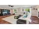 Spacious living room with hardwood floors, a large white sofa, bright windows, and stylish decor at 8056 Stevens Mill Rd, Matthews, NC 28104