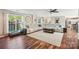 Open living room area featuring hardwood floors, a large white sofa, bright windows, and stylish decor at 8056 Stevens Mill Rd, Matthews, NC 28104