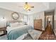 Comfortable main bedroom featuring vaulted ceilings, a ceiling fan, a cozy bed, and hardwood floors at 8056 Stevens Mill Rd, Matthews, NC 28104