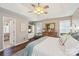 Comfortable main bedroom featuring vaulted ceilings, a ceiling fan, a cozy bed, and hardwood floors at 8056 Stevens Mill Rd, Matthews, NC 28104