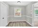Charming dining room featuring stylish trim, wood floors, and a large window at 8303 Hemby Wood Dr, Indian Trail, NC 28079