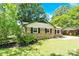 Charming brick home with black shutters and lush greenery provides an inviting curb appeal at 8303 Hemby Wood Dr, Indian Trail, NC 28079