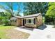 Quaint brick home boasts classic curb appeal, showcasing its inviting facade and manicured landscaping at 8303 Hemby Wood Dr, Indian Trail, NC 28079