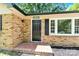 Inviting brick entryway leads to a classic black front door with decorative tiled landing at 8303 Hemby Wood Dr, Indian Trail, NC 28079