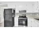 Functional kitchen featuring white cabinetry, essential appliances, and resilient countertops at 8303 Hemby Wood Dr, Indian Trail, NC 28079