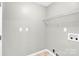Neutral laundry room with tile floors, shelving, and hookups at 8303 Hemby Wood Dr, Indian Trail, NC 28079