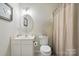 Bathroom with a vanity, toilet, and shower with curtain at 9204 Washam Potts Rd, Cornelius, NC 28031