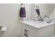 Elegant half bathroom with modern vanity, decorative accents, and a clean, crisp design at 9204 Washam Potts Rd, Cornelius, NC 28031