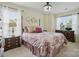 Bedroom with a four-poster bed, side tables, and ample natural light from large windows at 9204 Washam Potts Rd, Cornelius, NC 28031