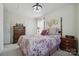 Cozy bedroom with a four-poster bed, side tables, and neutral decor at 9204 Washam Potts Rd, Cornelius, NC 28031