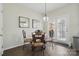Dining area with decorative light fixture, glass table, and dark wood floors at 9204 Washam Potts Rd, Cornelius, NC 28031