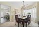 An inviting dining room with a wooden table, chandelier, and view into the updated kitchen at 9204 Washam Potts Rd, Cornelius, NC 28031