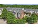Attractive three-story townhome boasting a brick facade, dormer windows, and professional landscaping at 9204 Washam Potts Rd, Cornelius, NC 28031