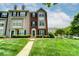 Charming brick and siding townhome with well-manicured lawn and inviting entrance at 9204 Washam Potts Rd, Cornelius, NC 28031
