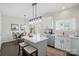 A bright kitchen with white cabinets, stainless appliances, an island and pendant lighting at 9204 Washam Potts Rd, Cornelius, NC 28031