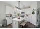 A bright kitchen with white cabinets, stainless appliances, an island and pendant lighting at 9204 Washam Potts Rd, Cornelius, NC 28031