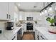 Modern kitchen features white cabinets, stainless appliances, and quartz counters at 9204 Washam Potts Rd, Cornelius, NC 28031