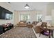 Cozy living room featuring ample seating, natural light, and a large decorative rug at 9204 Washam Potts Rd, Cornelius, NC 28031