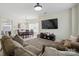 Spacious living area with large TV, comfortable sofa, and view into dining space at 9204 Washam Potts Rd, Cornelius, NC 28031