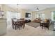 Open-concept living and dining area with bright windows, stylish furniture, and modern lighting at 9204 Washam Potts Rd, Cornelius, NC 28031