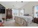 A cozy main bedroom with a four-poster bed and a view of the lush backyard at 9204 Washam Potts Rd, Cornelius, NC 28031