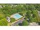 An aerial view of the community pool and tennis courts surrounded by mature trees and ample parking at 9204 Washam Potts Rd, Cornelius, NC 28031