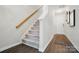 Clean staircase with carpeted steps and hardwood floors in the entryway, leading to the upper level at 9204 Washam Potts Rd, Cornelius, NC 28031