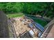 Aerial view of a stone patio with a firepit and ample seating surrounded by trees at 938 Rock Forest Way, Fort Mill, SC 29707
