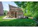 Spacious backyard featuring a multilevel deck, stone patio, and lush green lawn at 938 Rock Forest Way, Fort Mill, SC 29707