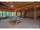 Unfinished basement with exposed ceiling, windows, and a ping pong table for entertainment at 938 Rock Forest Way, Fort Mill, SC 29707