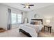 This bright bedroom has a ceiling fan, plush carpet, and an inviting double bed at 938 Rock Forest Way, Fort Mill, SC 29707