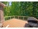 Inviting wood deck featuring outdoor seating and grill with a lush forest backdrop at 938 Rock Forest Way, Fort Mill, SC 29707