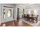Bright dining room features hardwood floors, elegant chandelier, and views of the landscaped front yard at 938 Rock Forest Way, Fort Mill, SC 29707