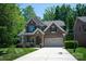 Charming two-story brick home boasts a manicured lawn, stone accents, and a basketball hoop on a paved driveway at 938 Rock Forest Way, Fort Mill, SC 29707
