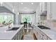 Open kitchen layout with a view of the dining area and sunroom, showcasing natural light and modern finishes at 938 Rock Forest Way, Fort Mill, SC 29707