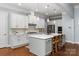 Spacious kitchen boasts a center island, stainless steel appliances, and ample storage with white cabinetry at 938 Rock Forest Way, Fort Mill, SC 29707