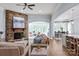 Inviting living room features a stone fireplace and an open layout to the sunroom and the kitchen area at 938 Rock Forest Way, Fort Mill, SC 29707