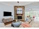 Cozy living room with stone fireplace, hardwood floors, plush seating, and ample natural light at 938 Rock Forest Way, Fort Mill, SC 29707