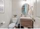 Cozy powder room features modern vanity with sink, oval mirror, and updated fixtures at 938 Rock Forest Way, Fort Mill, SC 29707