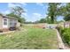 Spacious backyard with a fire pit area, mature trees, shed and plenty of green grass at 1005 N Main St, Mount Holly, NC 28120