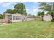 The house has a vast lawn, mature trees, a storage shed and a covered patio for entertainment at 1005 N Main St, Mount Holly, NC 28120