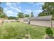 A wide-open backyard includes a fire pit area, storage shed, and mature trees, with a well-kept lawn at 1005 N Main St, Mount Holly, NC 28120