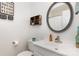 Cozy bathroom with white vanity, modern fixtures, and decorative mirror at 1005 N Main St, Mount Holly, NC 28120