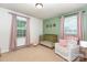 Charming Bedroom with neutral tones, window and gold colored crib at 1005 N Main St, Mount Holly, NC 28120