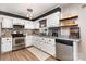 Bright kitchen featuring stainless steel appliances, white cabinetry, and updated countertops at 1005 N Main St, Mount Holly, NC 28120