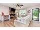 Inviting living room with brick fireplace, hardwood floors and comfortable seating at 1005 N Main St, Mount Holly, NC 28120