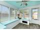 Bright sunroom featuring a built-in bench and access to the backyard at 1005 N Main St, Mount Holly, NC 28120