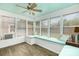 Bright sunroom with large windows and a cozy built-in bench seat at 1005 N Main St, Mount Holly, NC 28120