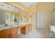Well-lit bathroom with double sinks and large mirror at 10223 Willingham Rd, Huntersville, NC 28078